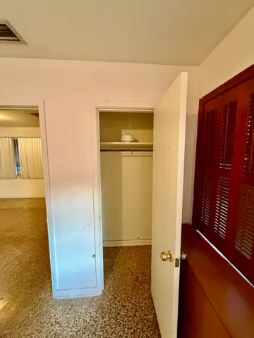 a wooden bench sitting in a bathroom