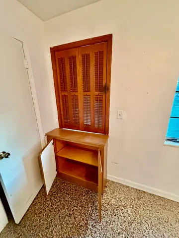 a view of cabinets and refrigerator