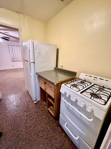 a stove top oven sitting inside of a kitchen