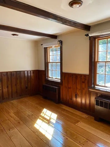 a view of wooden floor and windows in a room