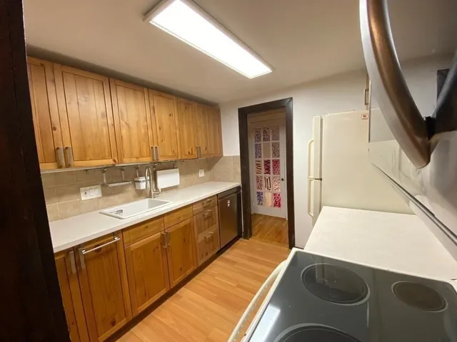 a kitchen with a sink a counter top space and cabinets