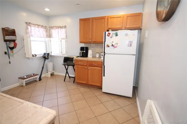a white refrigerator freezer sitting inside of a kitchen