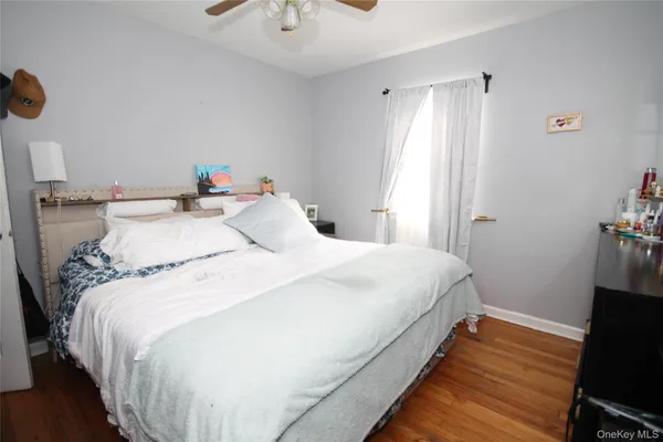 a large bed sitting in a bedroom next to a window