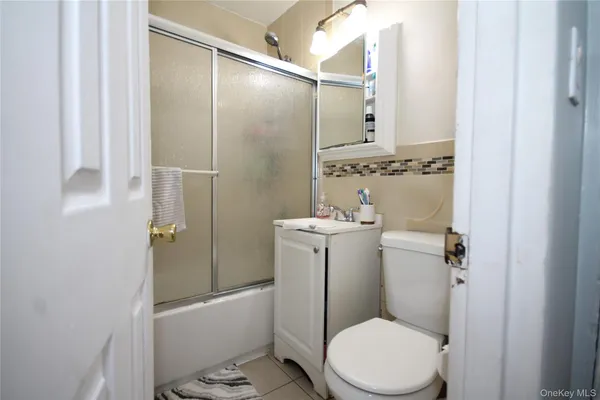 a bathroom with a toilet sink and shower