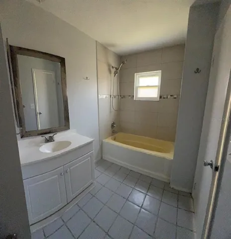 a bathroom with a sink a mirror and a bathtub