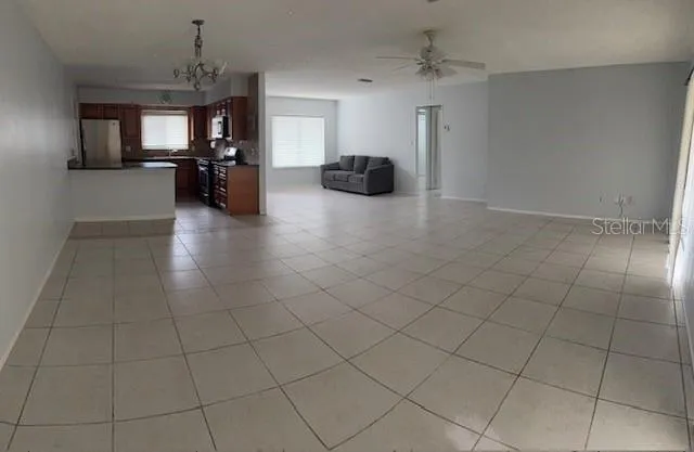 an empty room with furniture and windows