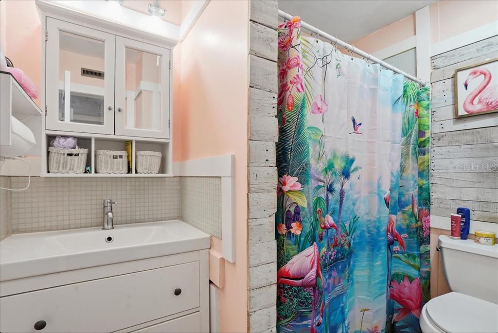 8931 Blind Pass Road, Unit 360 St. Pete Beach, FL 33706 - Photo 15 of 20 a bathroom with a sink toilet and shower