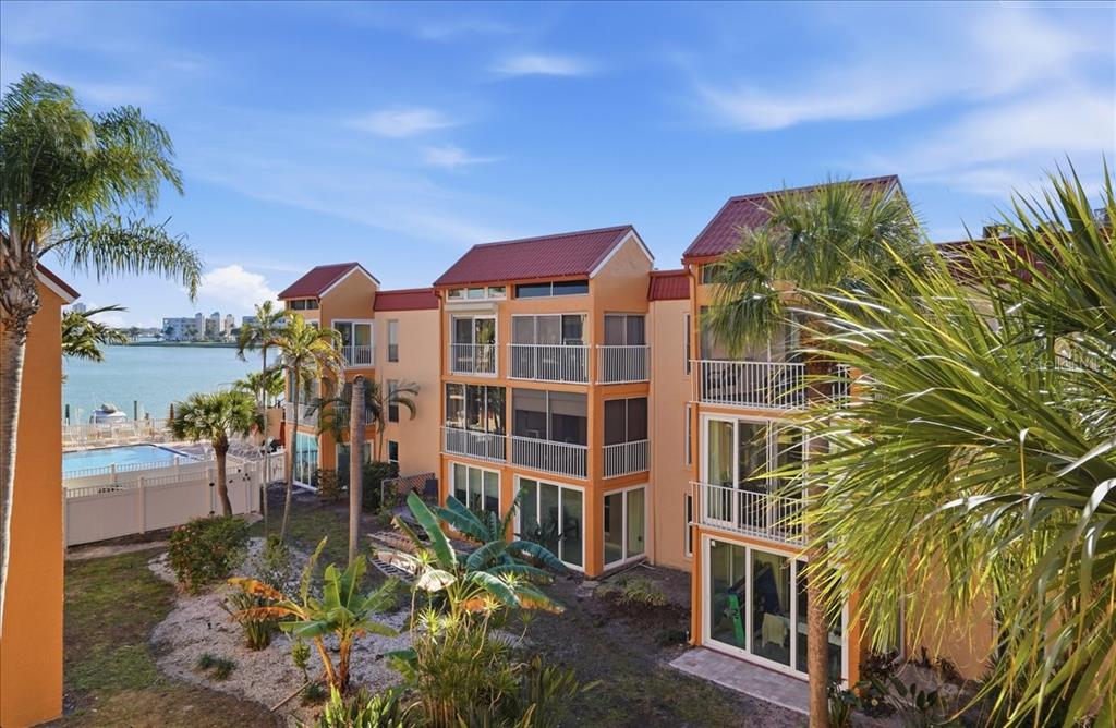 8931 Blind Pass Road, Unit 360 St. Pete Beach, FL 33706 - Photo 16 of 20 a view of a house with a yard