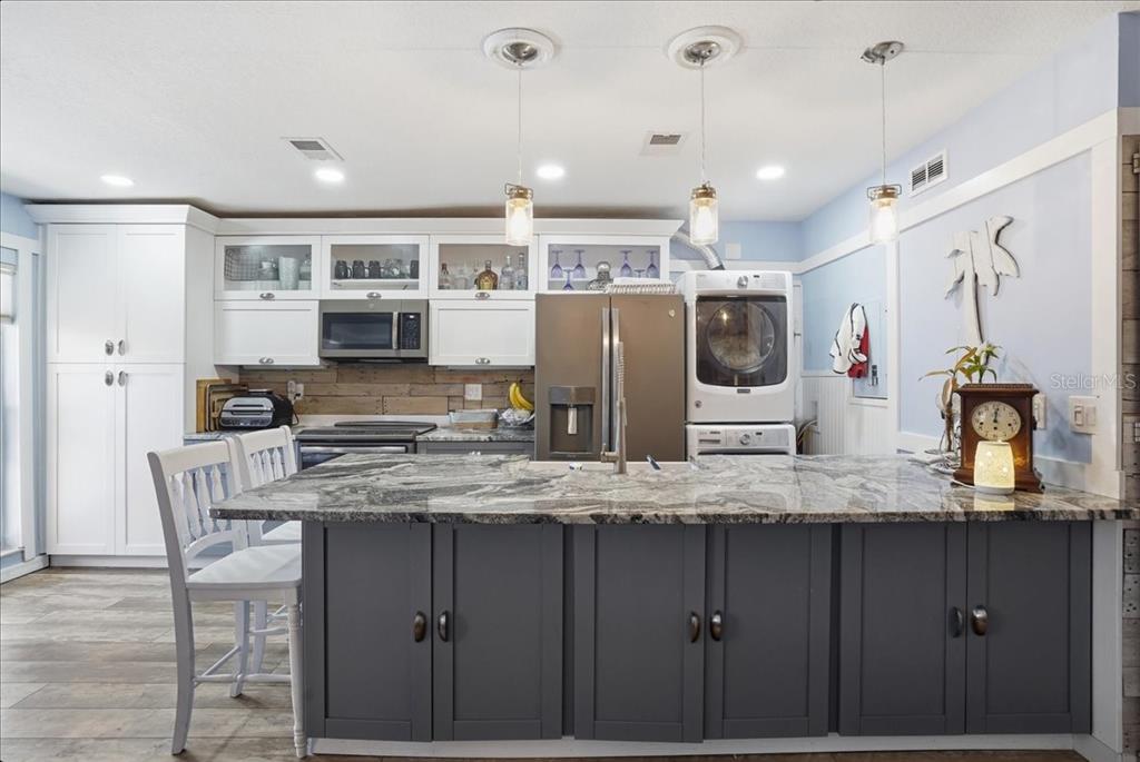 8931 Blind Pass Road, Unit 360 St. Pete Beach, FL 33706 - Photo 5 of 20 a kitchen with a refrigerator and microwave