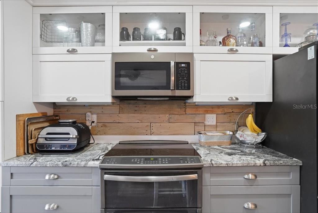 8931 Blind Pass Road, Unit 360 St. Pete Beach, FL 33706 - Photo 6 of 20 a stove top oven sitting inside of a kitchen