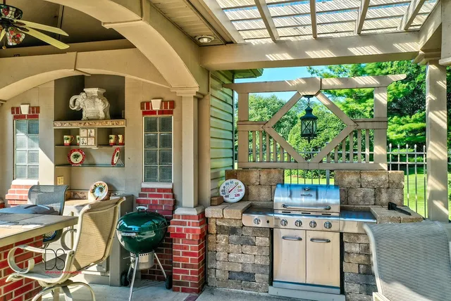 a open kitchen with stainless steel appliances granite countertop a stove a sink and a microwave