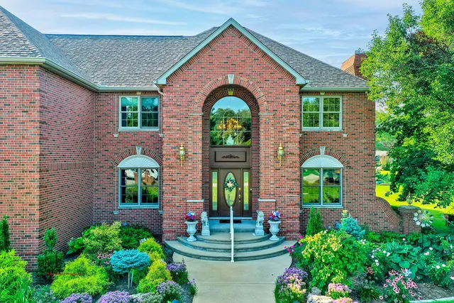 a front view of a house with garden