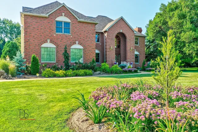 a front view of a house with a garden