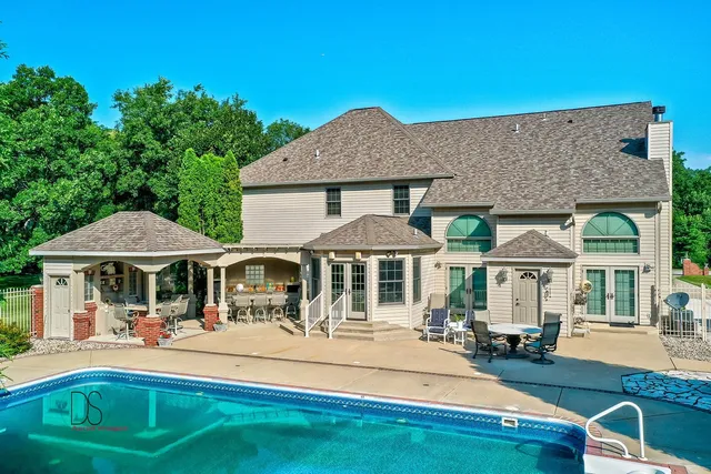 a front view of a house with yard patio and fire pit