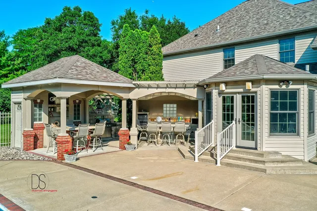 a patio with a table and chairs under an umbrella