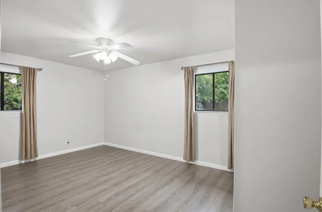 wooden floor in an empty room with a window