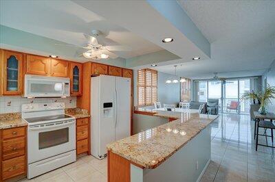 a kitchen with stainless steel appliances granite countertop a stove refrigerator and cabinets