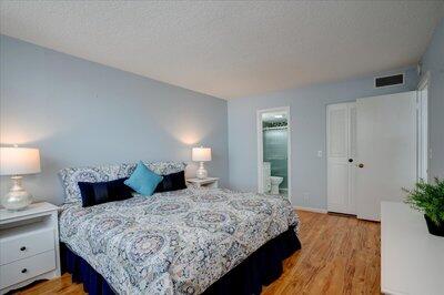 2018 South Federal Highway, Unit A301 Boynton Beach, FL 33435 - Photo 14 of 32 a bedroom with a bed and a potted plant on dresser