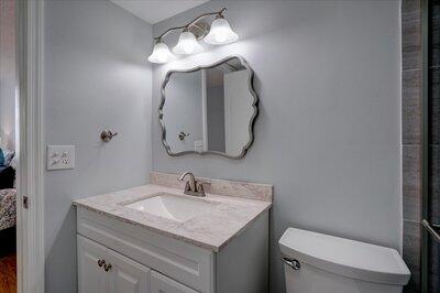 2018 South Federal Highway, Unit A301 Boynton Beach, FL 33435 - Photo 16 of 32 a bathroom with a toilet sink and mirror
