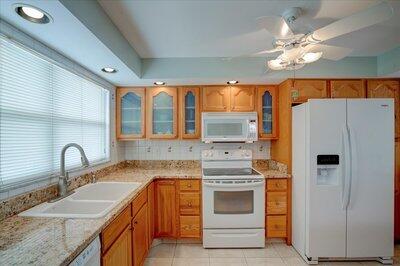 2018 South Federal Highway, Unit A301 Boynton Beach, FL 33435 - Photo 2 of 32 a kitchen with stainless steel appliances a stove a sink and a refrigerator