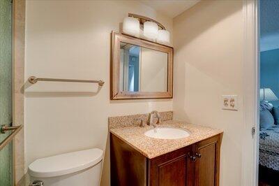 2018 South Federal Highway, Unit A301 Boynton Beach, FL 33435 - Photo 21 of 32 a bathroom with a granite countertop toilet sink and mirror