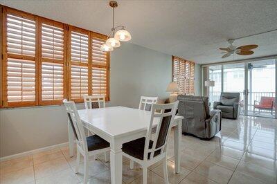 2018 South Federal Highway, Unit A301 Boynton Beach, FL 33435 - Photo 6 of 32 a view of a dining room and livingroom with furniture wooden floor a chandelier