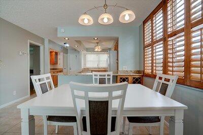 2018 South Federal Highway, Unit A301 Boynton Beach, FL 33435 - Photo 7 of 32 a view of a dining room with furniture and a large window