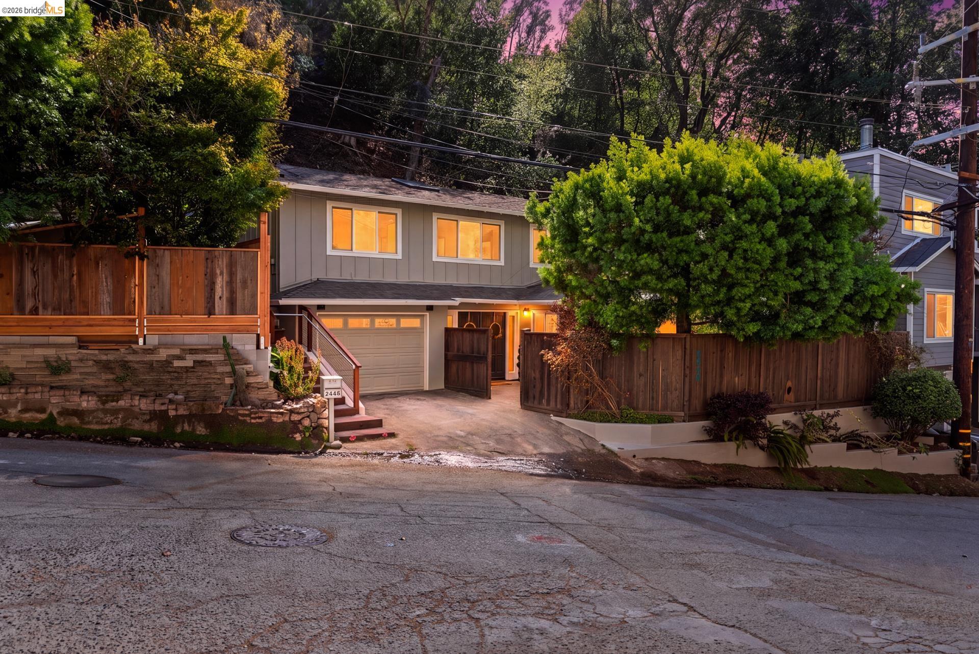 6660 Sobrante Road Oakland, CA 94611 - Photo 45 of 48 Two-story residence with light gray siding and white trim windows