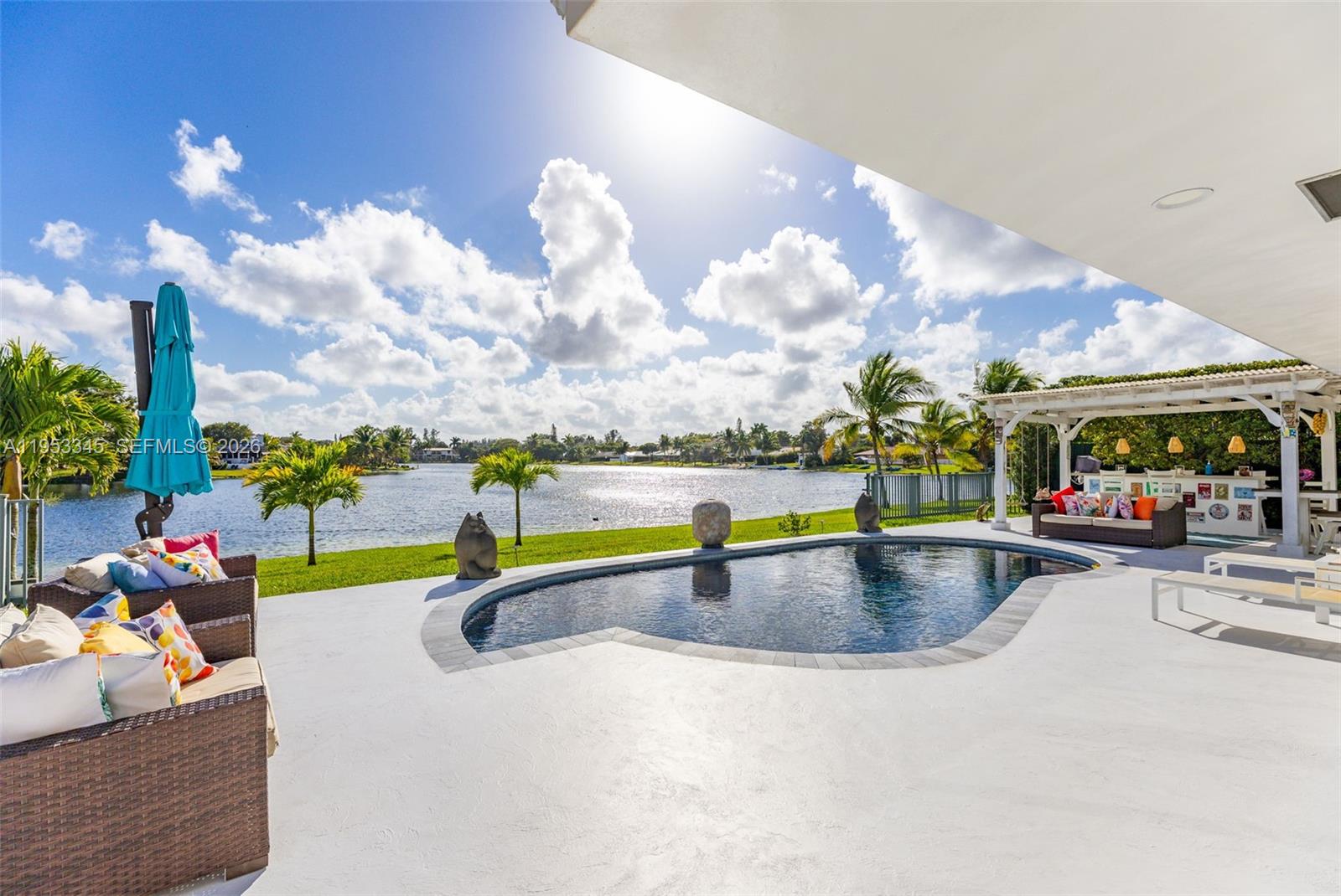 6830 Winged Foot Drive Hialeah, FL 33015 - Photo 14 of 28 a view of a swimming pool and a patio