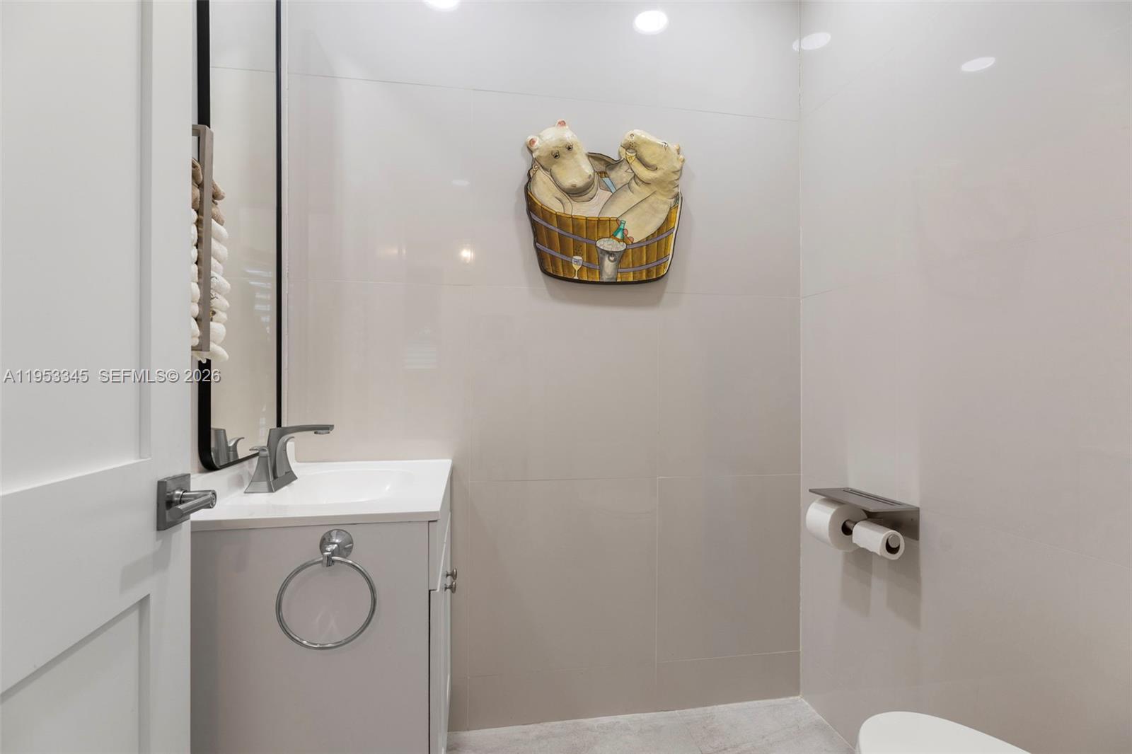 6830 Winged Foot Drive Hialeah, FL 33015 - Photo 17 of 28 a bathroom with a sink and a mirror