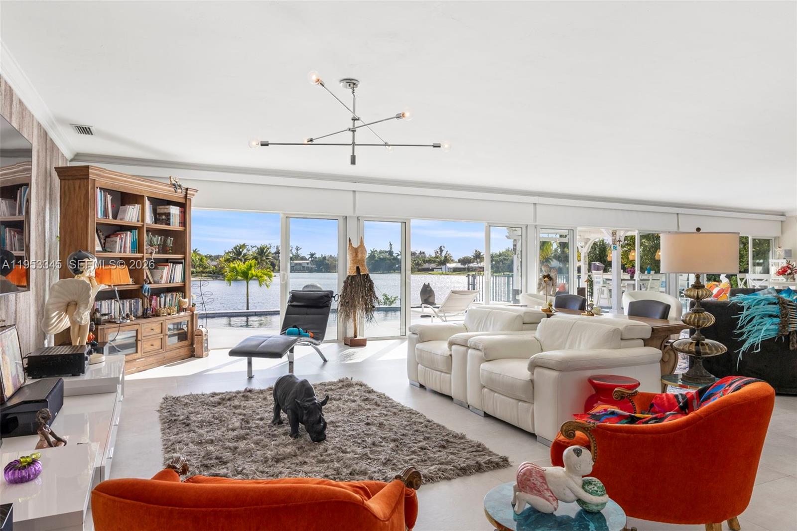 6830 Winged Foot Drive Hialeah, FL 33015 - Photo 19 of 28 a living room with furniture and a book shelf