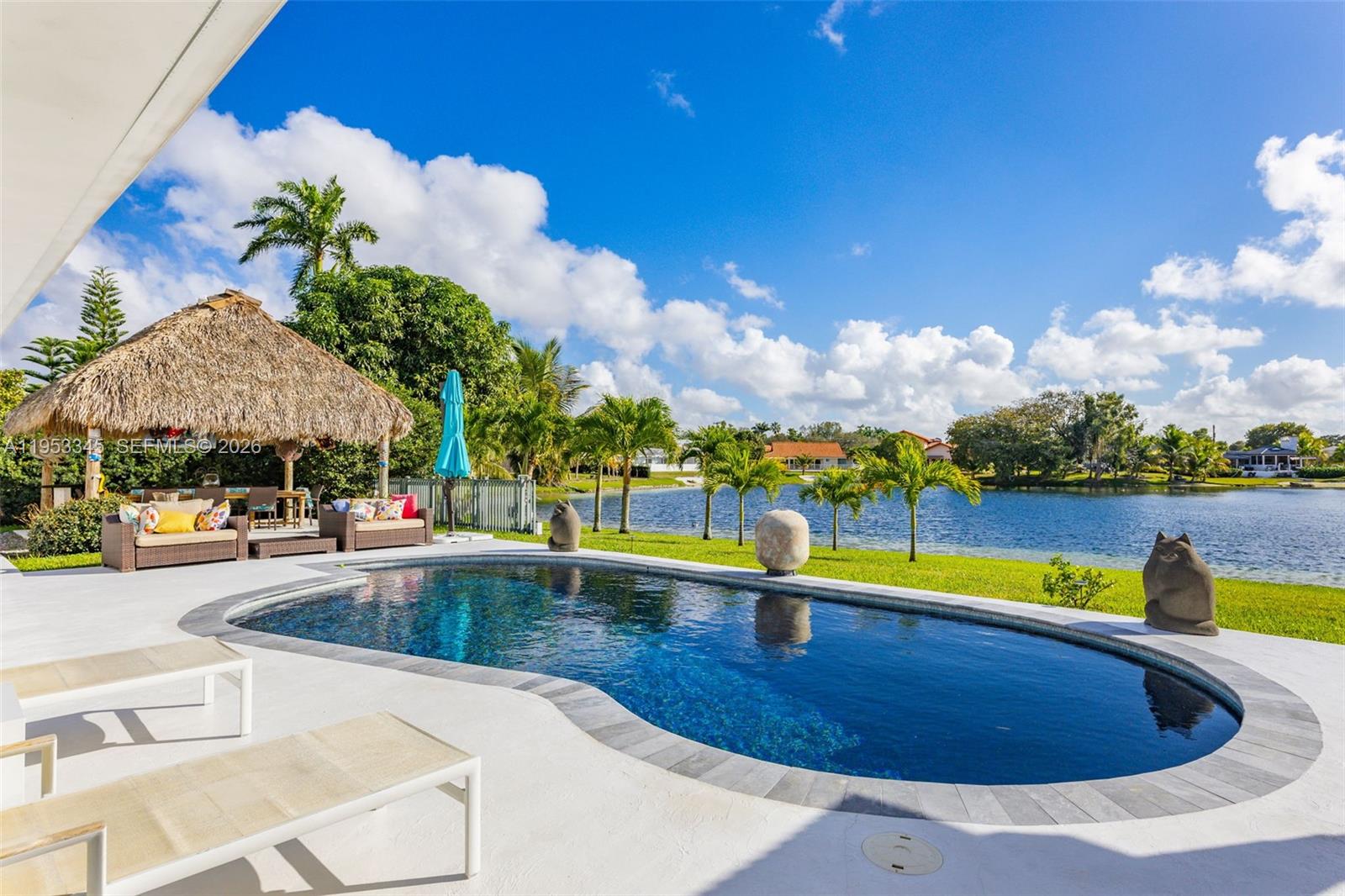 6830 Winged Foot Drive Hialeah, FL 33015 - Photo 2 of 28 a view of a swimming pool with lounge chairs