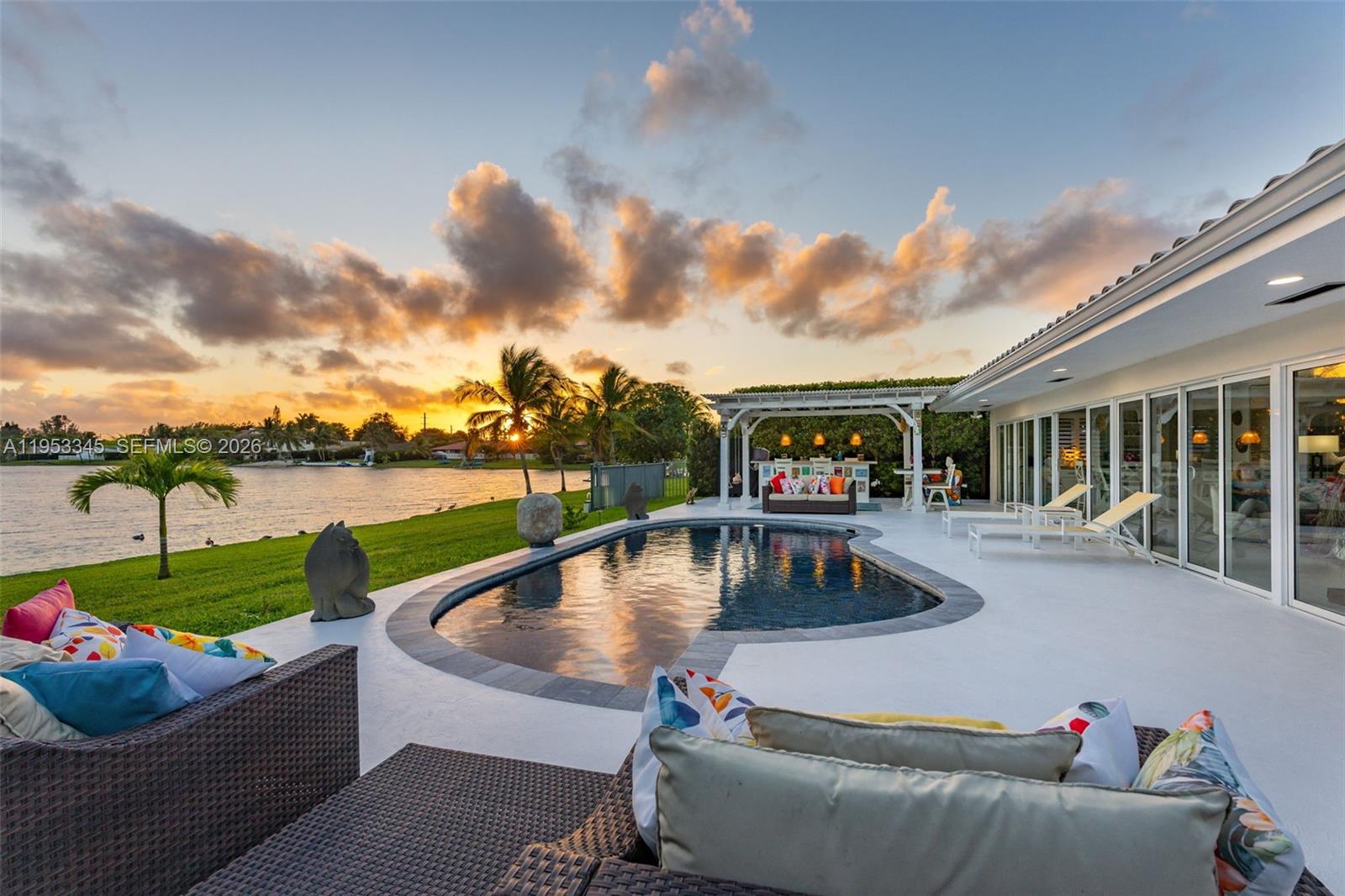 6830 Winged Foot Drive Hialeah, FL 33015 - Photo 23 of 28 a view of swimming pool with lounge chair and a garden