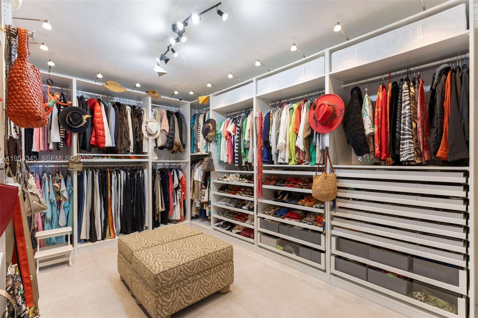 6830 Winged Foot Drive Hialeah, FL 33015 - Photo 7 of 28 a view of walk in closet with clothes and shoes