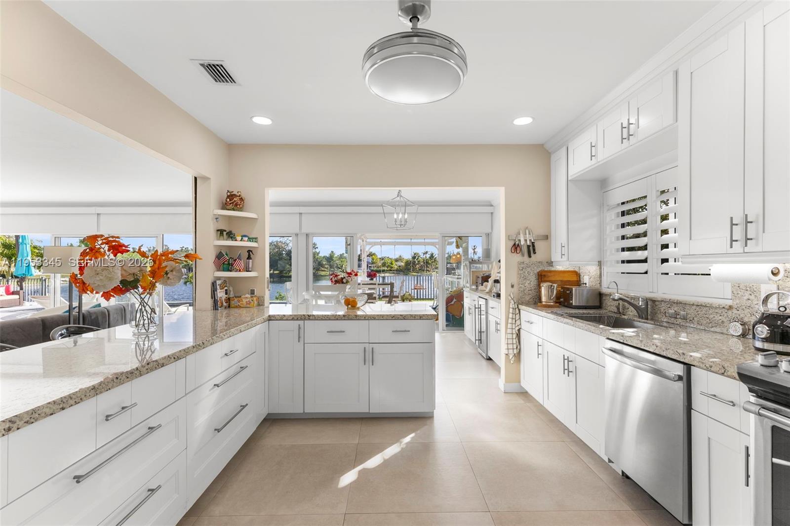 6830 Winged Foot Drive Hialeah, FL 33015 - Photo 10 of 28 a kitchen with stainless steel appliances a sink stove and cabinets
