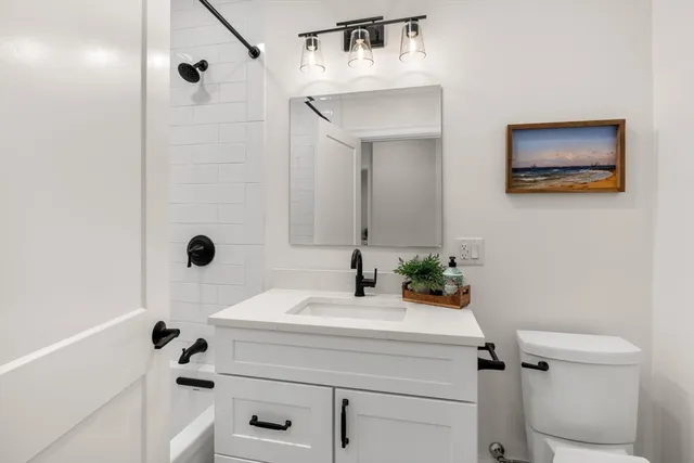 a bedroom with furniture and a potted plant