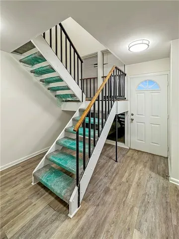 a view of entryway and hall with wooden floor