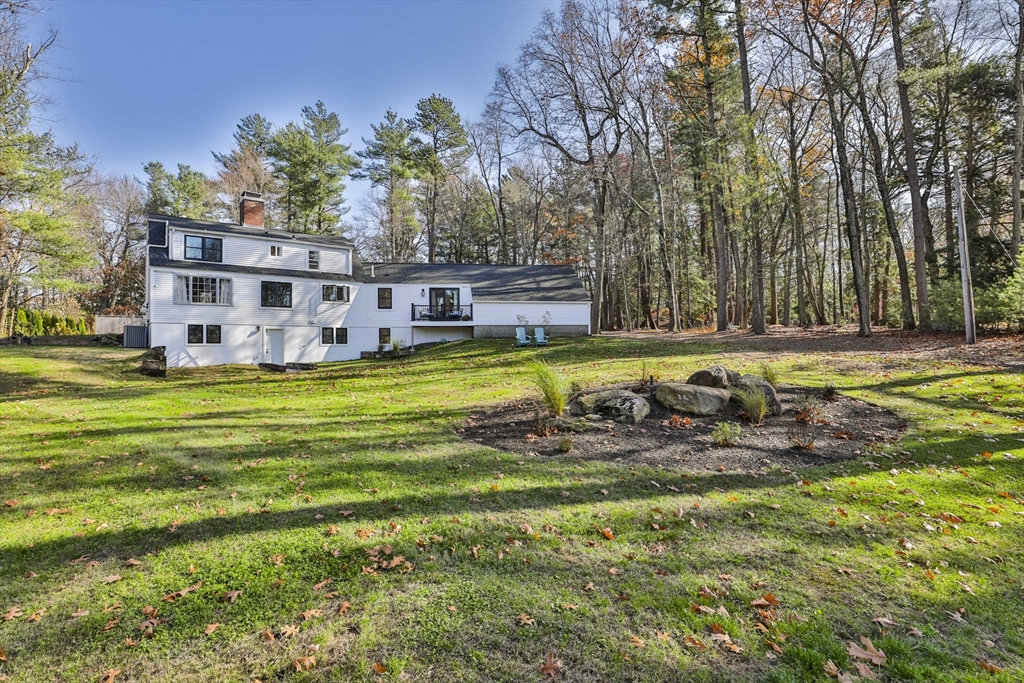 60 Bolton Road Harvard, MA 01451 - Photo 28 of 30 a view of a swimming pool with lawn chairs and plants