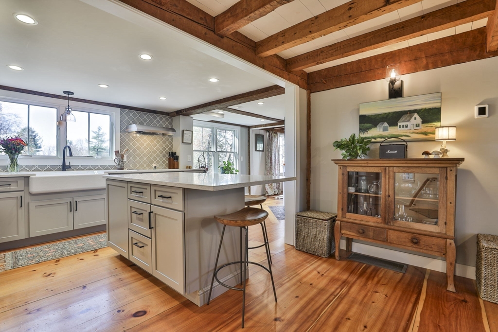 60 Bolton Road Harvard, MA 01451 - Photo 3 of 30 a kitchen with kitchen island granite countertop wooden floors and stainless steel appliances
