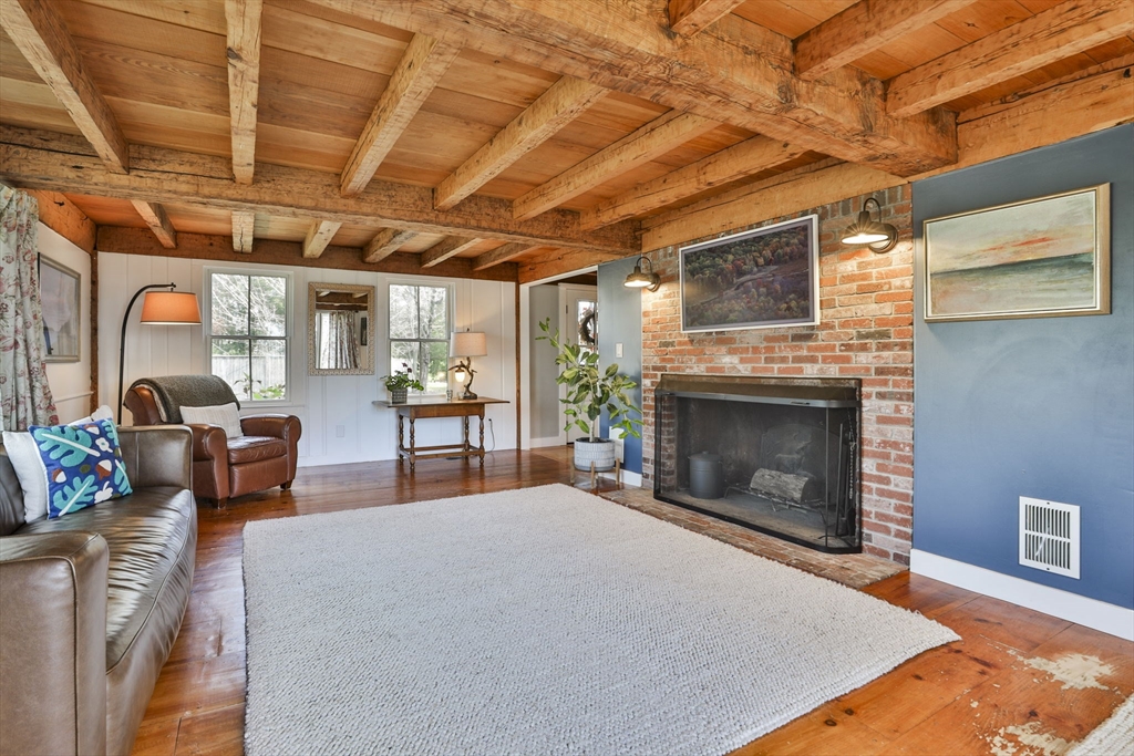 60 Bolton Road Harvard, MA 01451 - Photo 10 of 30 a living room with furniture a fireplace and a table