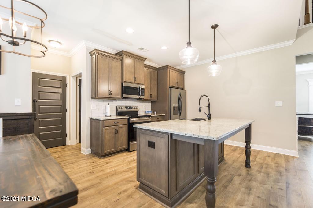 135 Timber Ridge Boulevard Byron, GA 31008 - Photo 11 of 36 a kitchen with a sink appliances and cabinets
