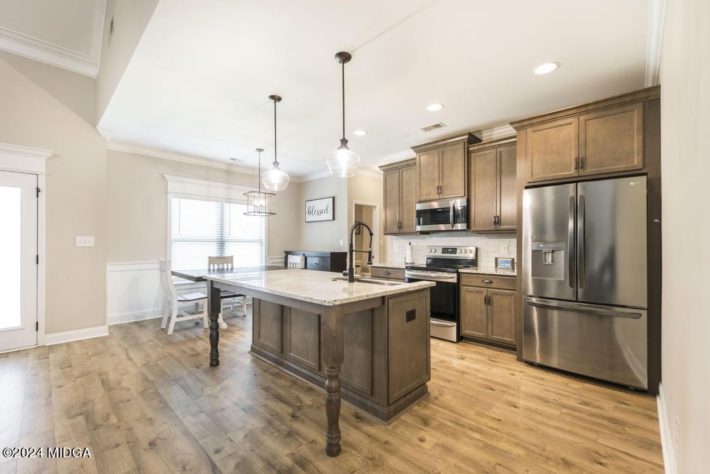135 Timber Ridge Boulevard Byron, GA 31008 - Photo 14 of 36 a kitchen that has a lot of cabinets in it and stainless steel appliances