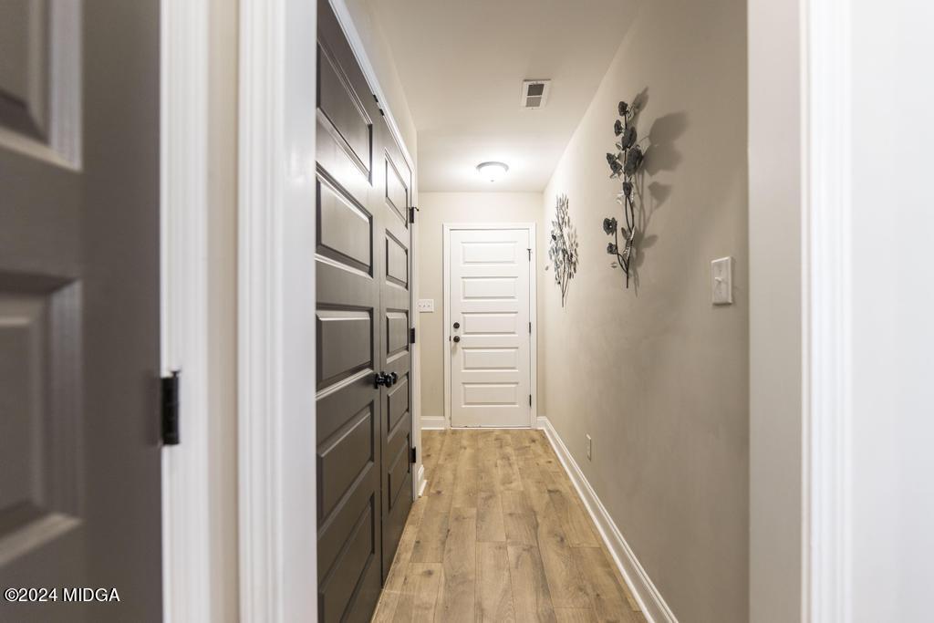 135 Timber Ridge Boulevard Byron, GA 31008 - Photo 18 of 36 a view of a hallway with wooden floor and staircase