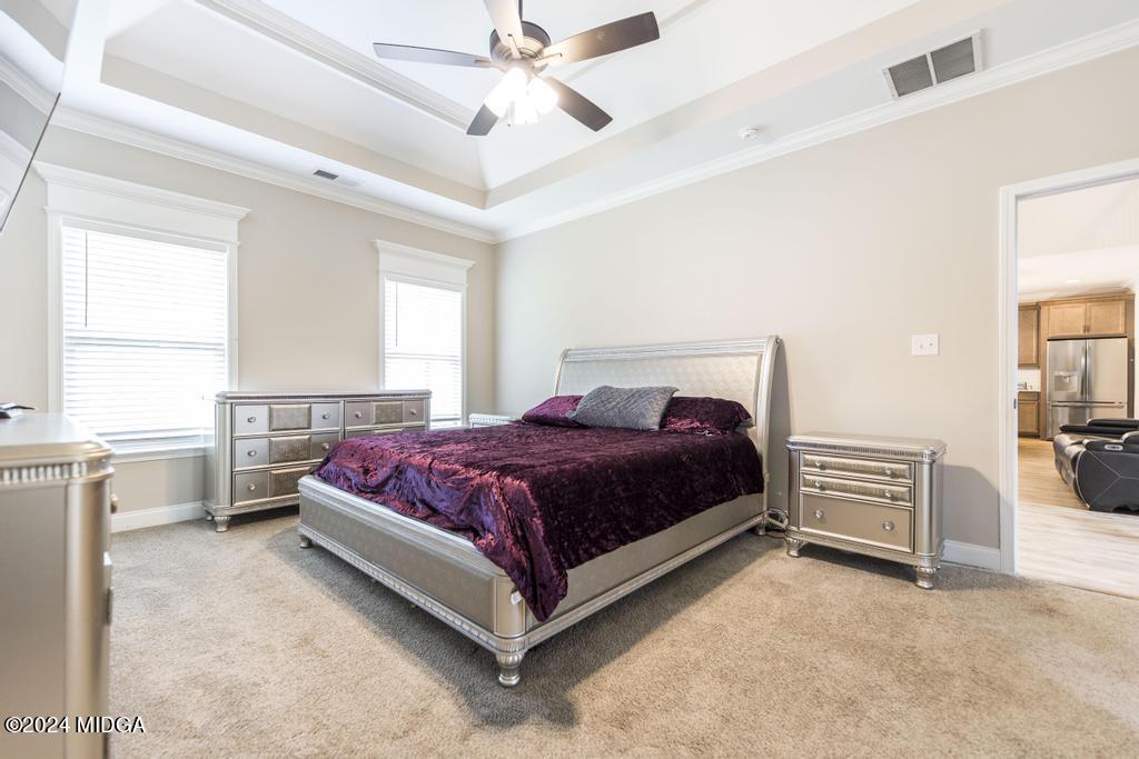 135 Timber Ridge Boulevard Byron, GA 31008 - Photo 19 of 36 a spacious bedroom with a bed and a cabinets
