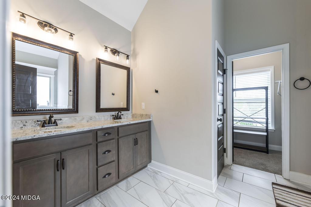 135 Timber Ridge Boulevard Byron, GA 31008 - Photo 21 of 36 a bathroom with a double vanity sink and mirror