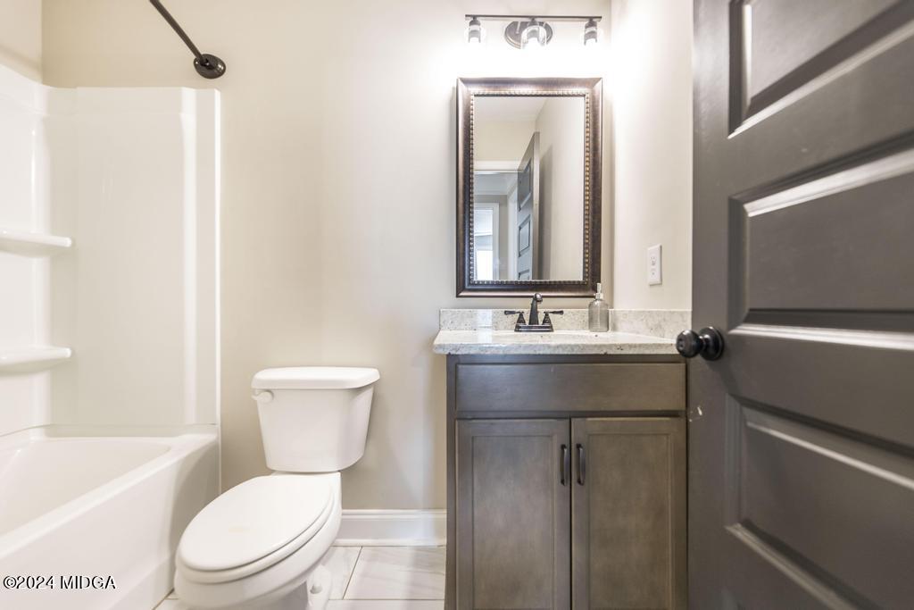 135 Timber Ridge Boulevard Byron, GA 31008 - Photo 29 of 36 a bathroom with a toilet sink and mirror