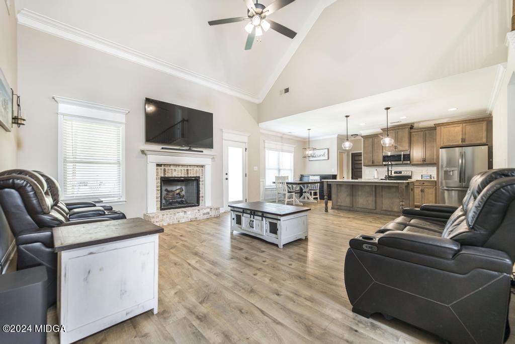 135 Timber Ridge Boulevard Byron, GA 31008 - Photo 6 of 36 a living room with furniture kitchen view and a fireplace