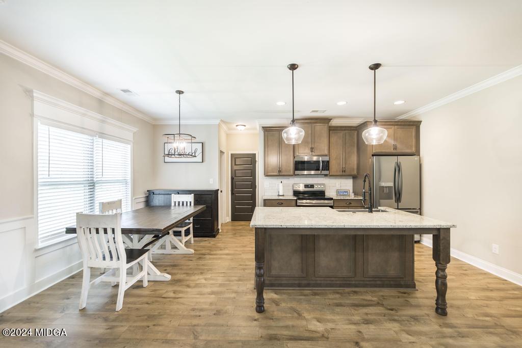 135 Timber Ridge Boulevard Byron, GA 31008 - Photo 9 of 36 a view of kitchen with sink and dining table