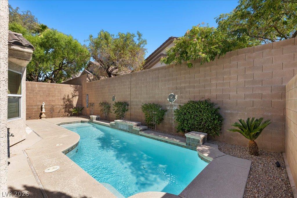 2627 Dirleton Place Henderson, NV 89044 - Photo 1 of 42 An inviting backyard oasis awaits with a sparkling pool, perfect for leisure.