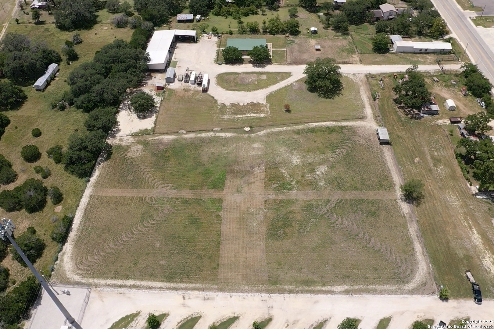 an aerial view of residential house with pool and yard